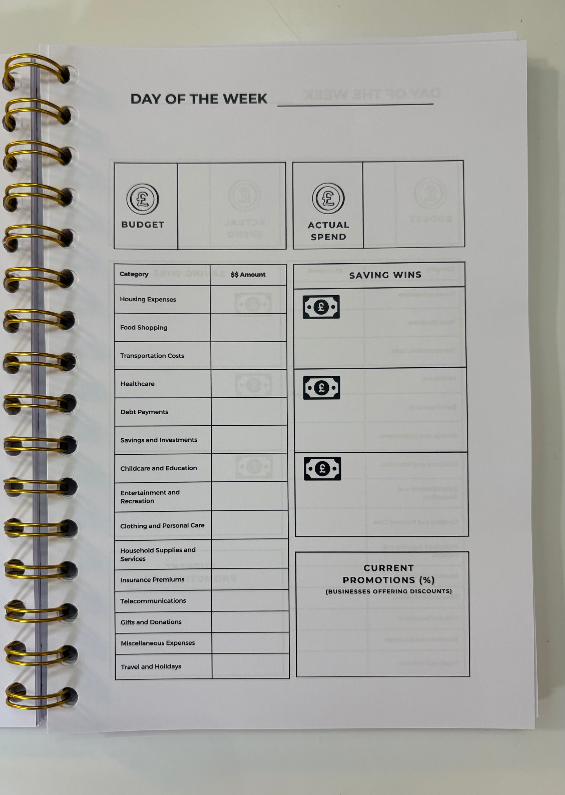 Spiral-bound notebook with budgeting and expense tracking pages on a white background