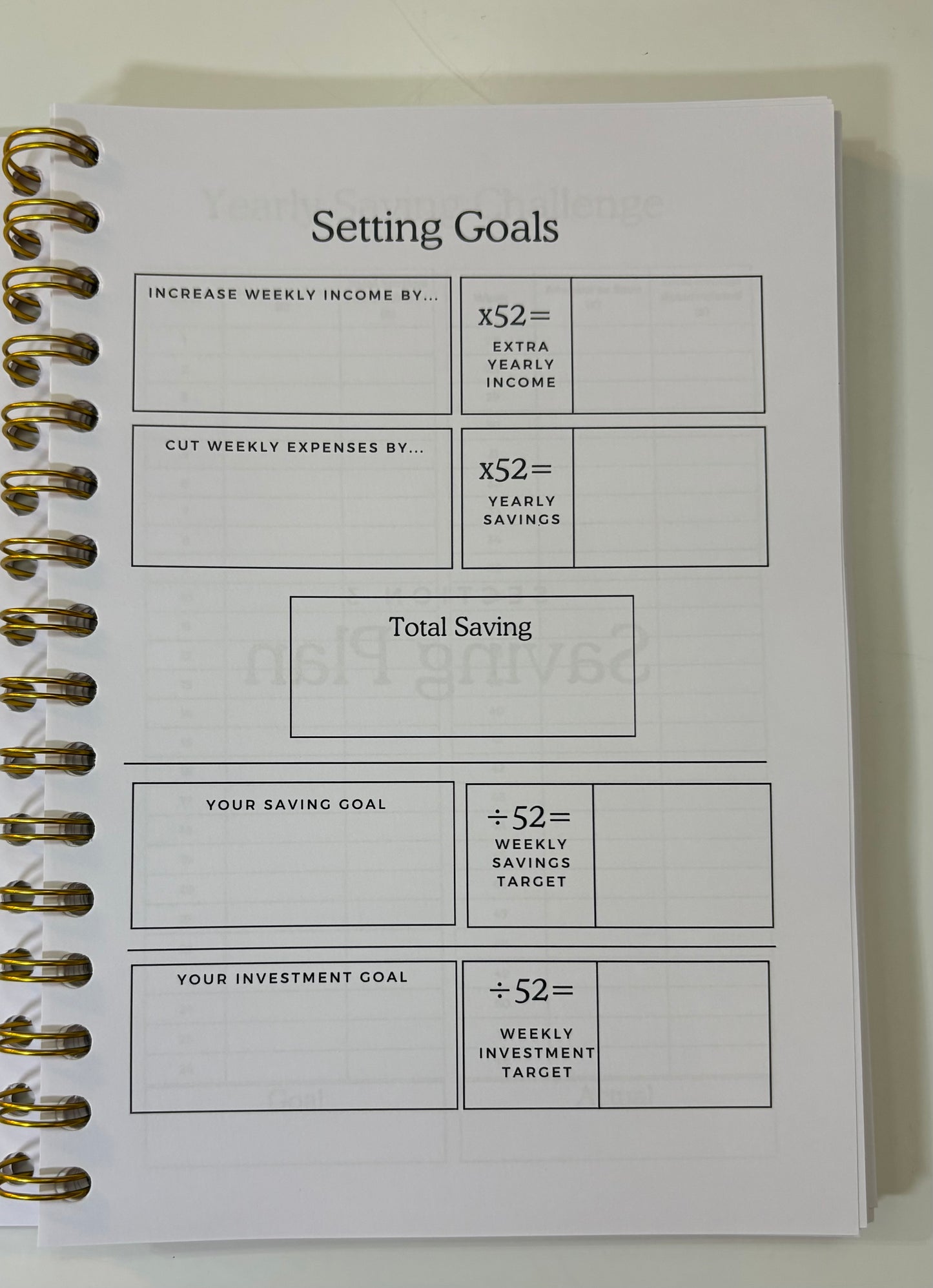 Goal-setting worksheet in a spiral-bound notebook on a white background