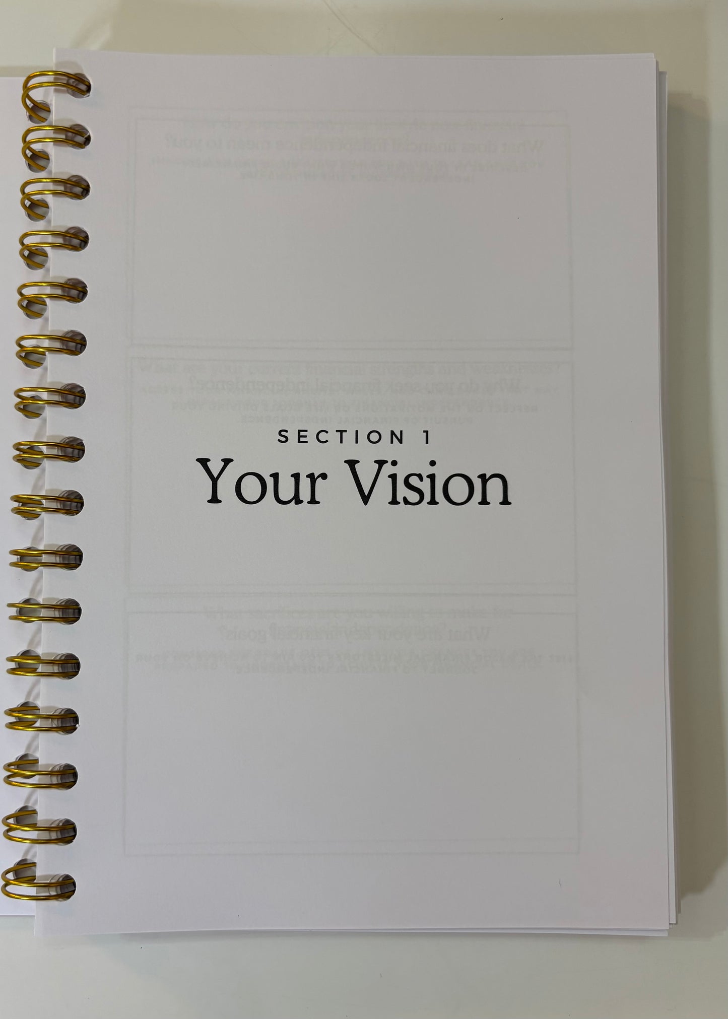 Notebook with 'Section 1 Your Vision' text on a white background