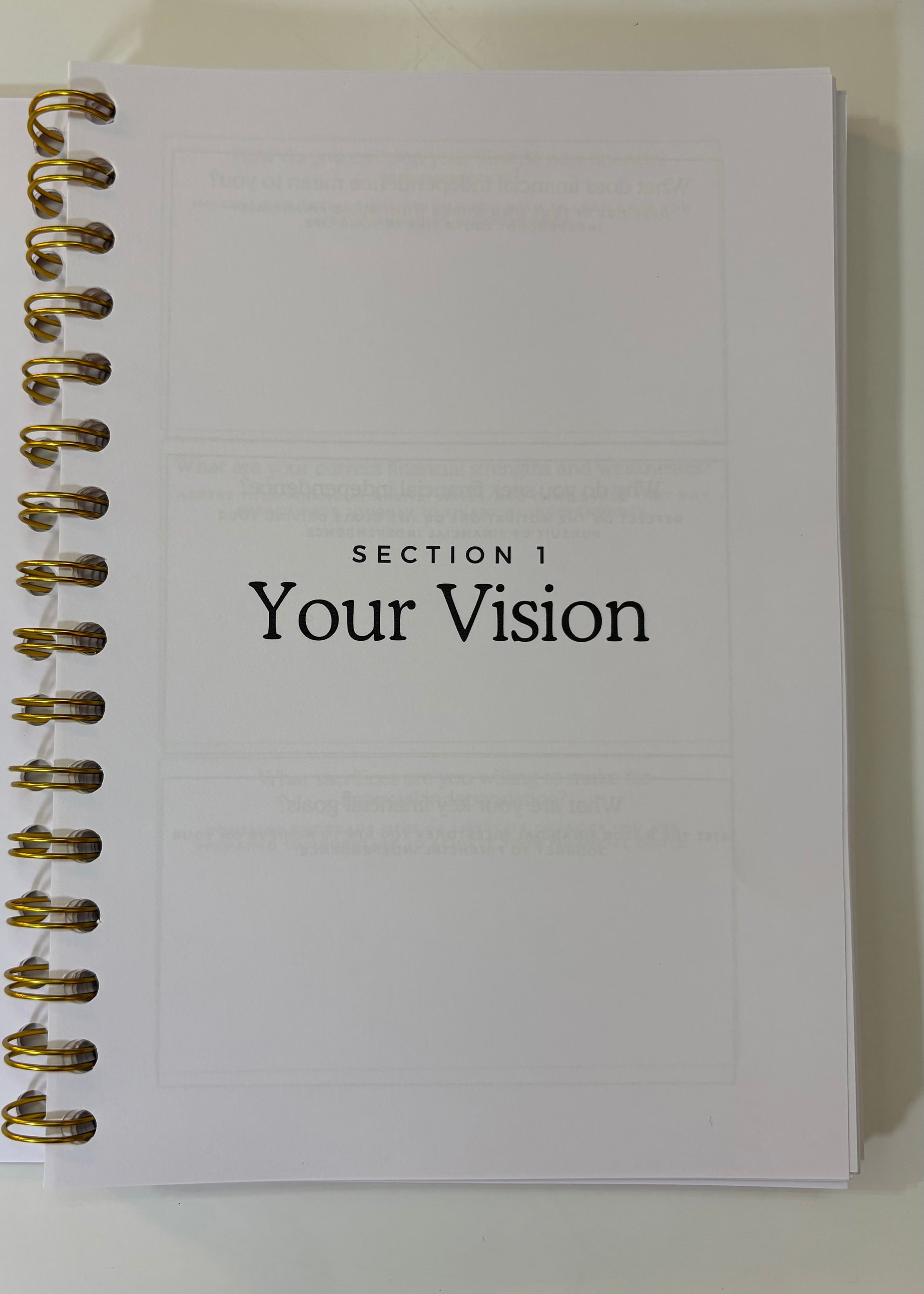 Notebook with 'Section 1 Your Vision' text on a white background